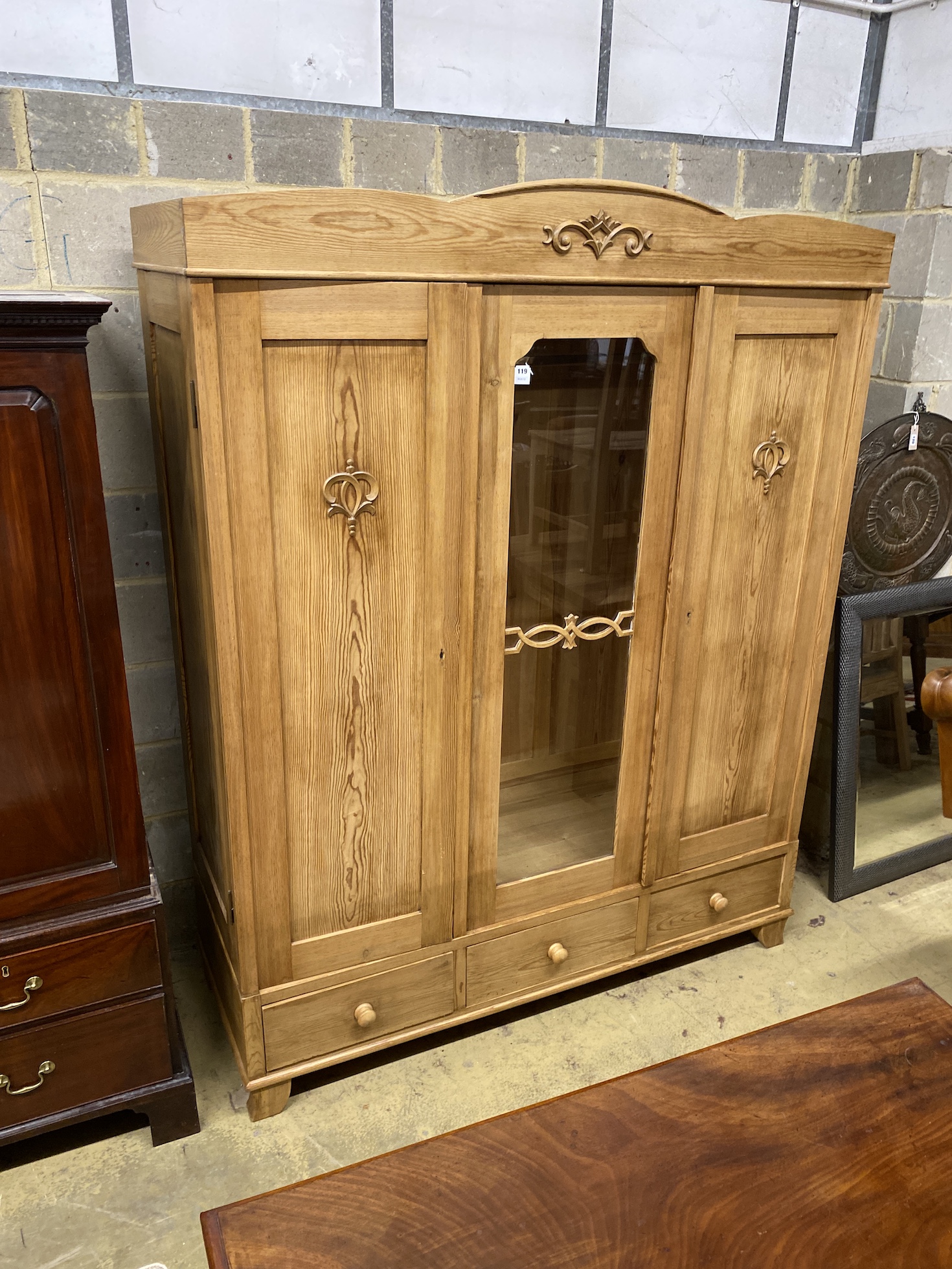 An East European style glazed pine triple wardrobe, width 161cm, depth 60cm, height 199cm